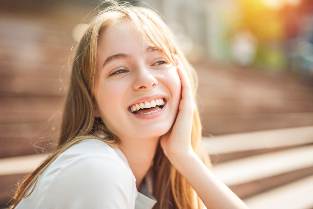 A woman enjoys her day with a radiant smile after visiting an emergency dentist who quickly resolved her dental concern. – Emergency Dentist Seattle