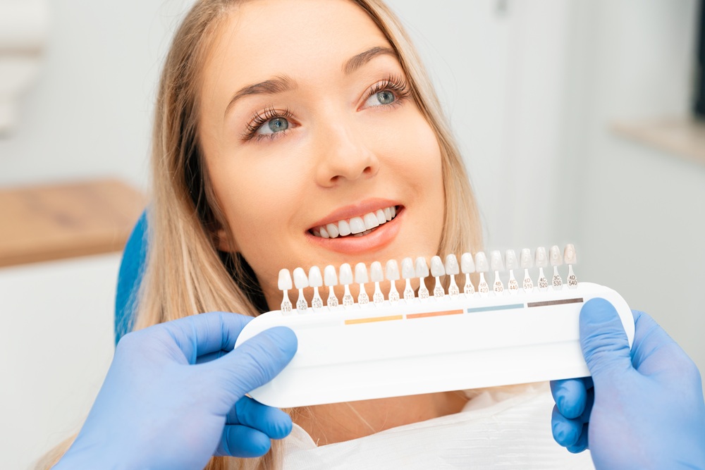 Tooth Shade Matching for Smile Makeover – Cosmetic Dentistry A dentist compares tooth shades to help a patient choose the perfect color for veneers or whitening treatment, ensuring a natural and radiant smile. – Cosmetic Dentistry