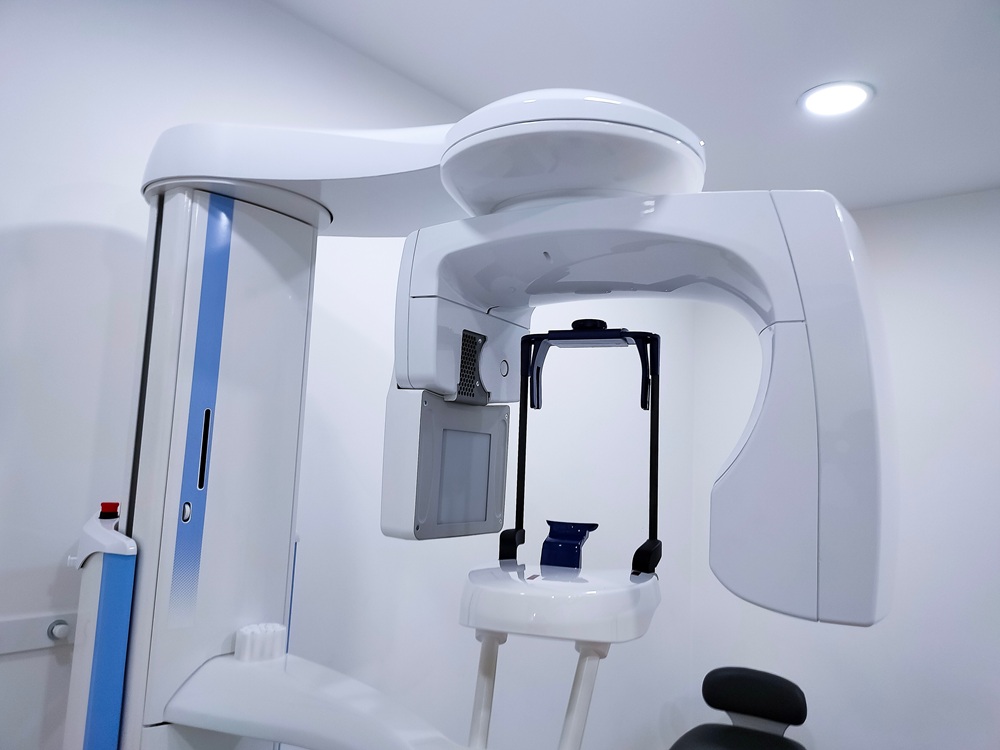 Advanced Dental Imaging Equipment – Cone Beam CT Scan A modern dental cone beam CT scanner used for 3D imaging and precise diagnosis of oral structures, ensuring accurate treatment planning and improved patient outcomes. – Cone Beam CT Scan
