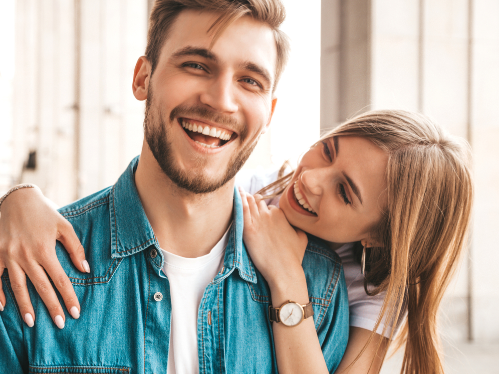 A cheerful couple shows off their bright smiles, reflecting the confidence and comfort restored after receiving prompt emergency dental care. – Emergency Dentist Seattle